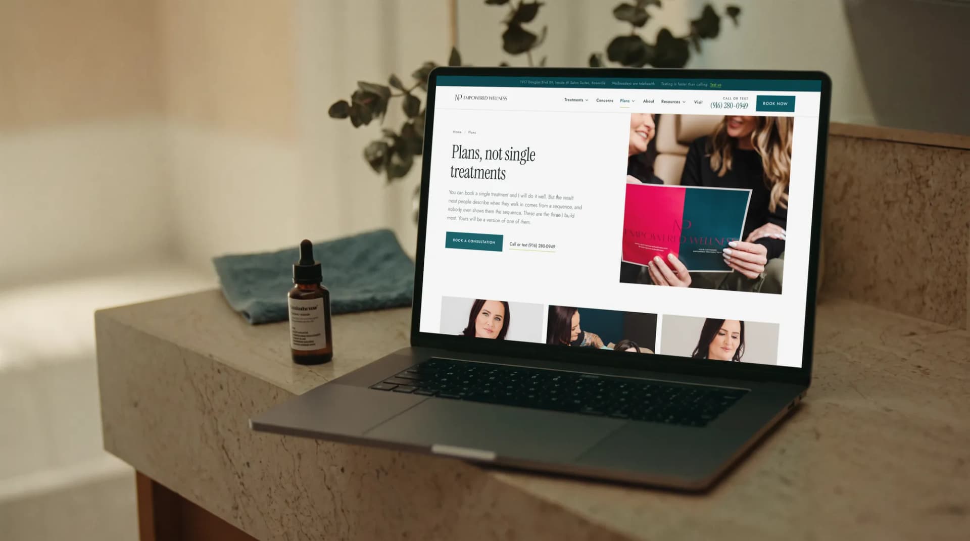 The NP Empowered Wellness plans page on a laptop on a bathroom vanity in morning light