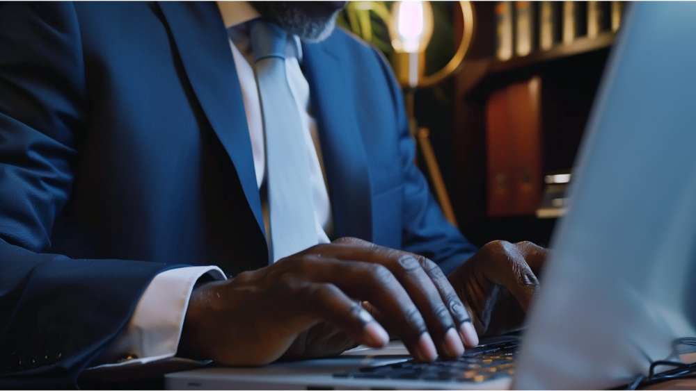 A lawyer writing an article on his laptop